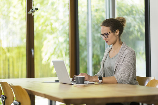 Woman at home working on laptop