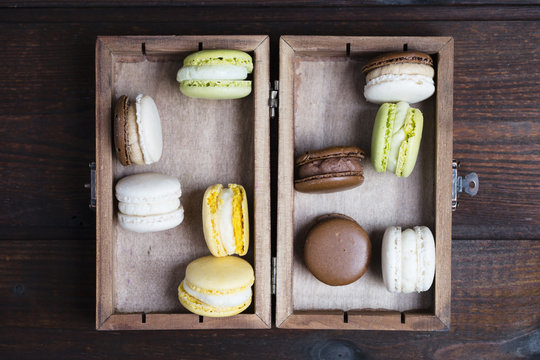 Different macarons in a wooden box