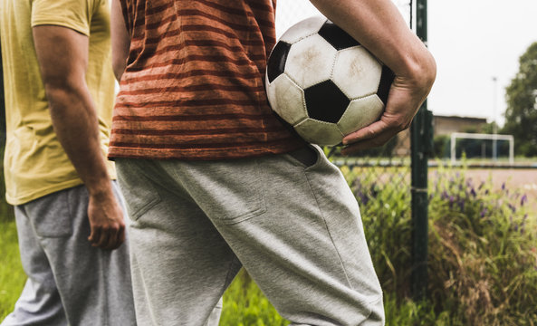 Close-up of two men with football