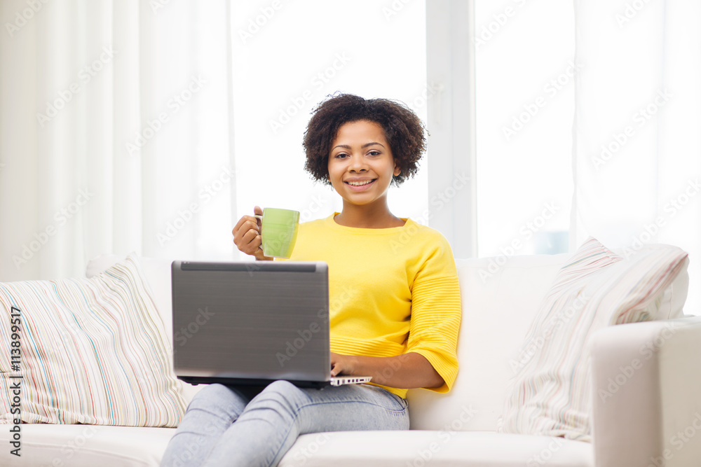 Wall mural happy african american woman with laptop at home