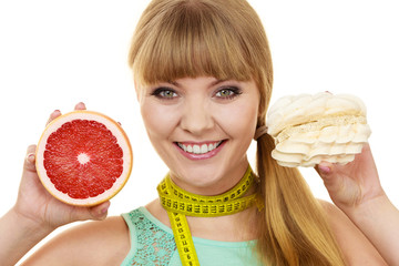 Woman choosing fruit or cake make dietary choice