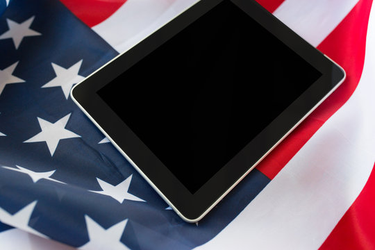 close up of tablet pc computer on american flag - Powered by Adobe