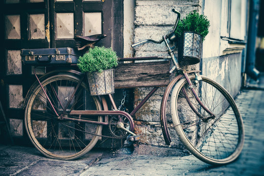 Vintage stylized photo of old bicycle carrying flower pots 