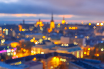 Out-of-focus shimmering city background, blurred bokeh photo of old town at sunset, Tallinn, Estonia