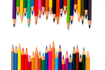 Row of color pencil placed on white background
