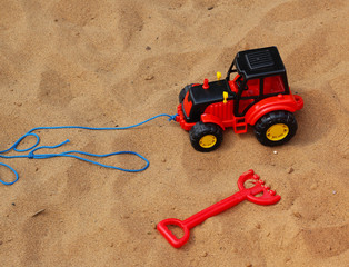 Red fork beach toy and excavator