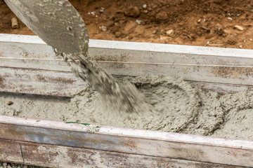 Detail of shovel while filling the foundations of a wall with mortar