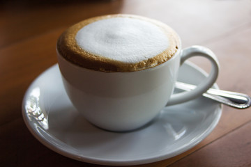Cup of latte art coffee with froth milk