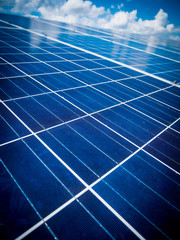 Solar panels with blue sky and clouds