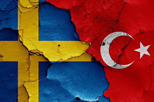 flags of Sweden and Turkey painted on cracked wall