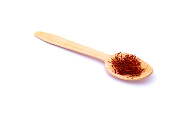 Saffron in wooden spoons isolated on white close-up