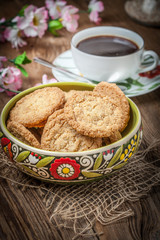 Stack of freshly baked oat biscuits in a bowl.
