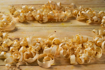 Carpenter tools on wood table background with sawdust. Copy space