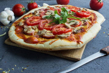 homemade pizza with sausage and tomatoes.