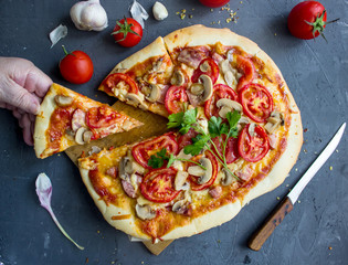 homemade pizza with sausage and tomatoes