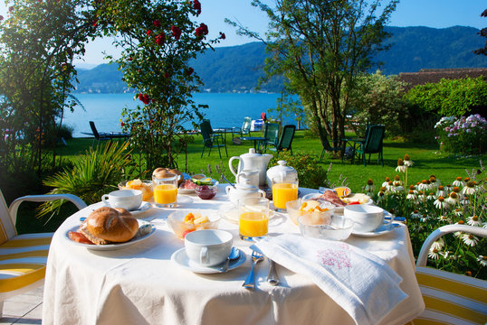 Set The Table With Breakfast On The Green Lawn In Front Of The Lake