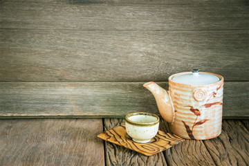 Still life of set of japanese ceramic teapot and cup on wooden t