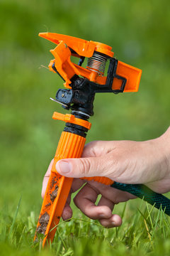 hand with garden sprinkler