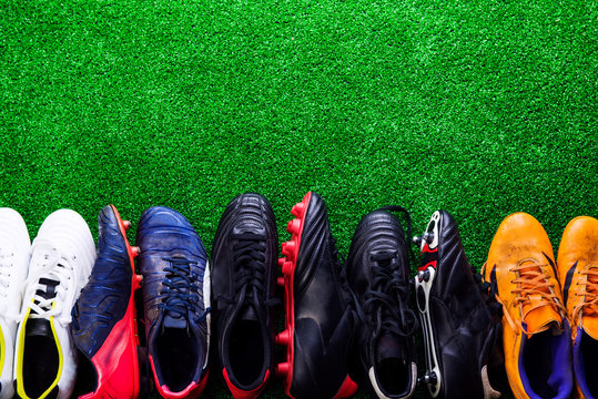 Various cleats against green artificial turf, studio shot