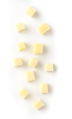 Parmesan cheese cubes on white background. Top view.