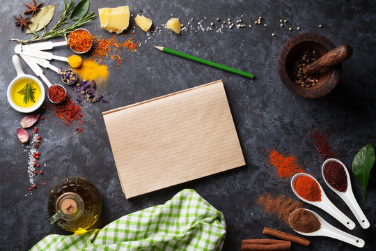 Herbs and spices over black stone