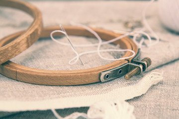 Set for embroidery, embroidery hoop and embroidery thread. Coloring and processing photos in vintage style with soft selective focus. Shallow depth of field