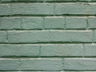Textured background closeup. Turquoise old brick wall