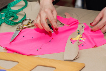 Obraz premium Sewing textile or cloth. Work table of a tailor. Textile tools. Scissors reel of thread, measuring tapes and natural fabric. Copy space