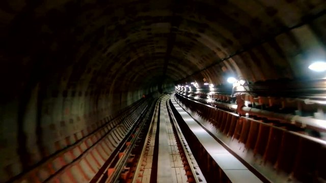 Movement through subway underground tunnel/View through the window of train driver in subway underground tunnel
