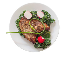 Pork chop with vegetables on a plate