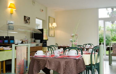 Hotel restaurant interior with served tables for breakfast
