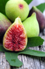 Healthy organic green figs in bowl on rustic wooden table