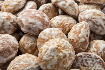 Pile of round gingerbread small cakes with sugar powder