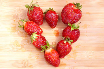 Strawberry in the form of heart on a chopping board