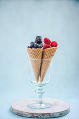 ice cream cones with fresh berries