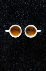 two cups of fresh Coffee Espresso on black Marble