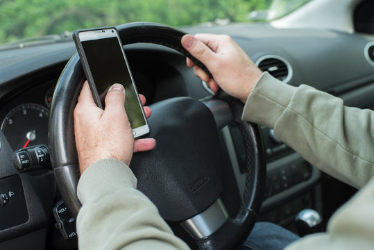 Man using phone while driving