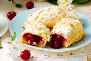 Pies from puff pastry with cherry