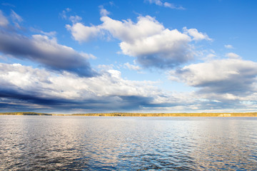 Fototapeta premium Blue Skies and Clouds Over Evening Lake in Finland