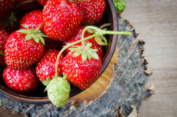 Fresh ripe organic strawberry on wooden background. Rustic style.