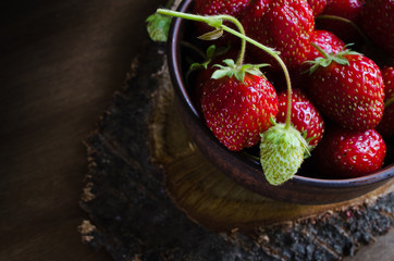 Fresh ripe organic strawberry on wooden background. Rustic style.