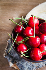 Fresh ripe organic cherries on wooden background. Rustic style.