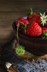 Fresh ripe organic strawberry on wooden background. Rustic style.