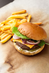 Delicious homemade hamburger with french fries on wooden vintage table