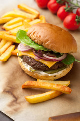 Delicious homemade hamburger with french fries on wooden vintage table