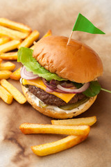 Delicious homemade hamburger with french fries on wooden vintage table