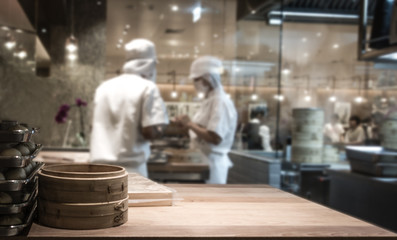 Blurred background of chefs cooking in  open kitchen