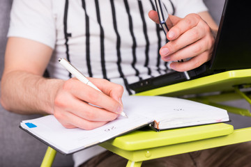 Close up of businessman's hand writing