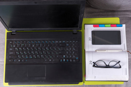 Top view of a tabletop workstation with open laptop