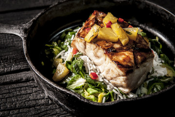 Pan frying a large piece of white fish